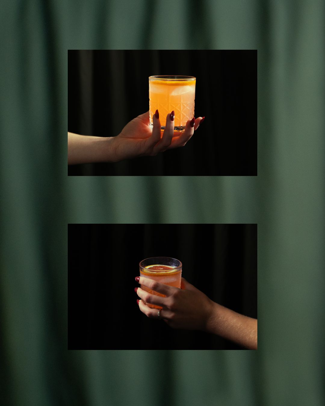 Two hands holding glowing orange cocktails against a dark backdrop, framed on green drapery.
